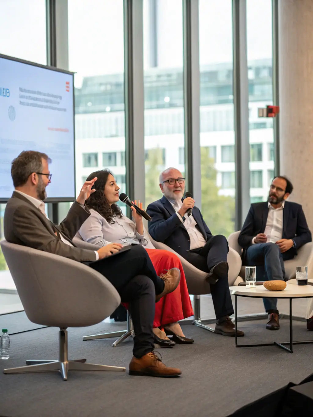 A high-quality image of a panel discussion at a financial summit in Cape Town, South Africa, featuring prominent economists and business leaders. The atmosphere should be serious and engaging.